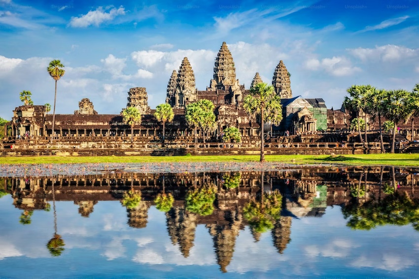 Angkor Wat temple complex reflected in a lotus-filled pond in Cambodia