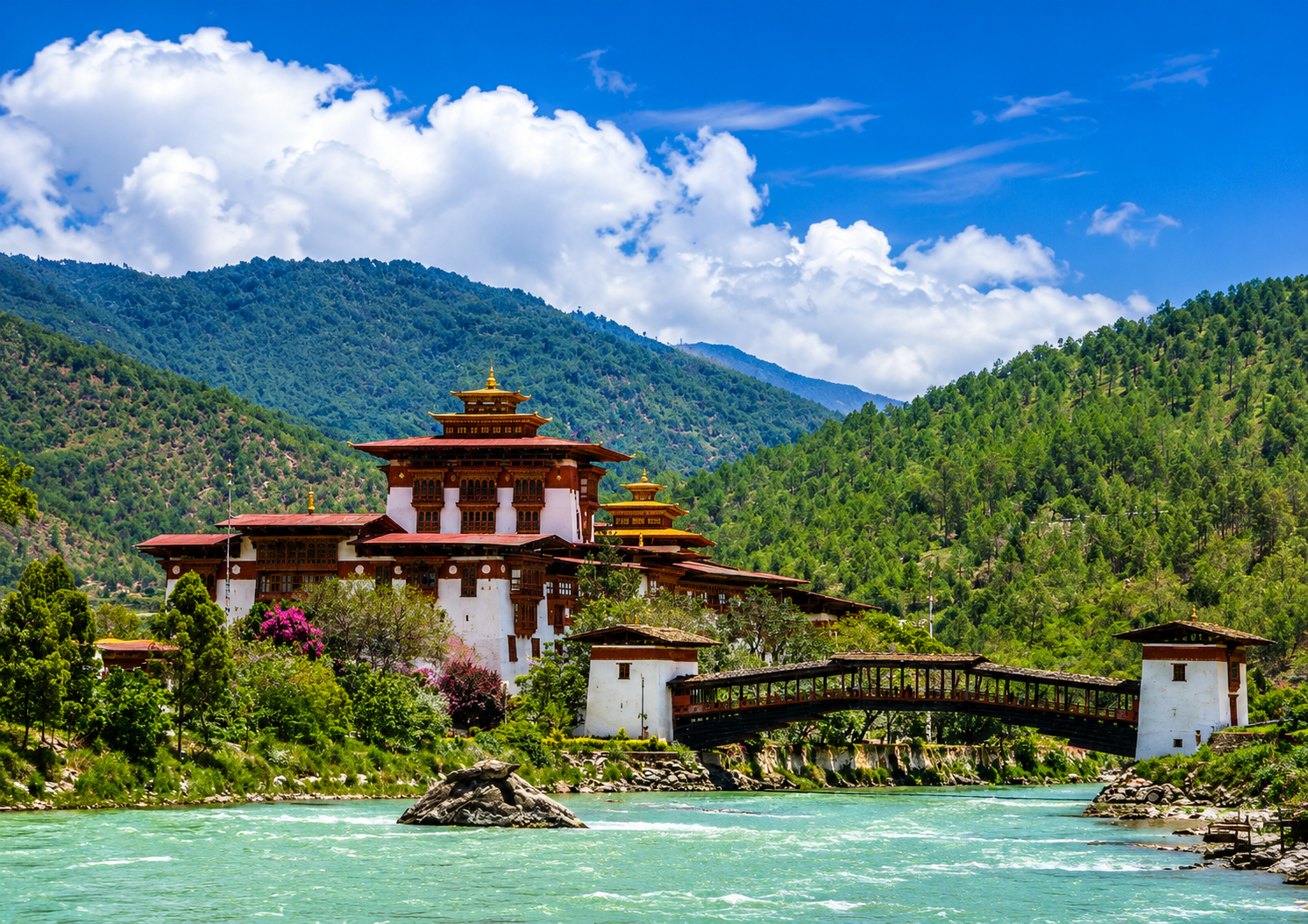 Punakha Dzong in western Bhutan with a traditional bridge, river, and green mountains