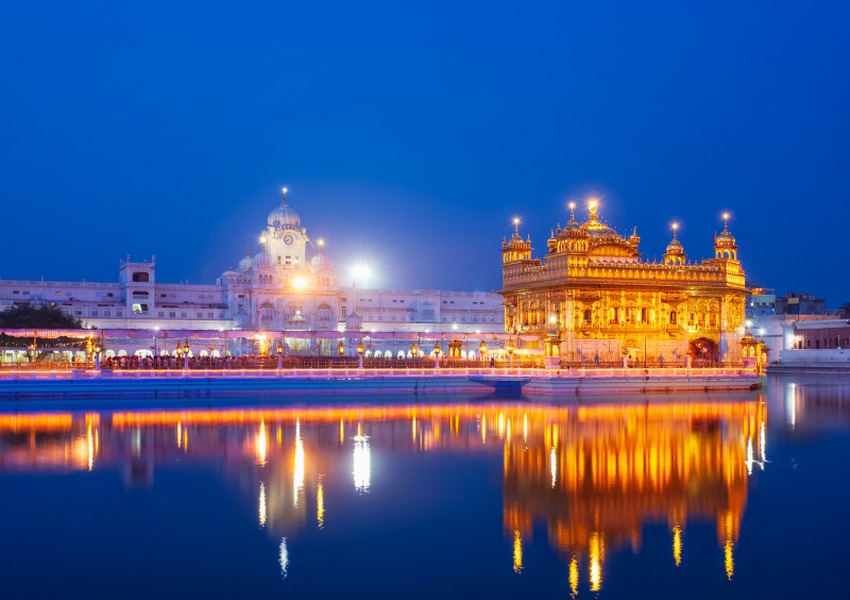 Golden Temple illuminated at night with its reflection in the sacred water, Amritsar, India.