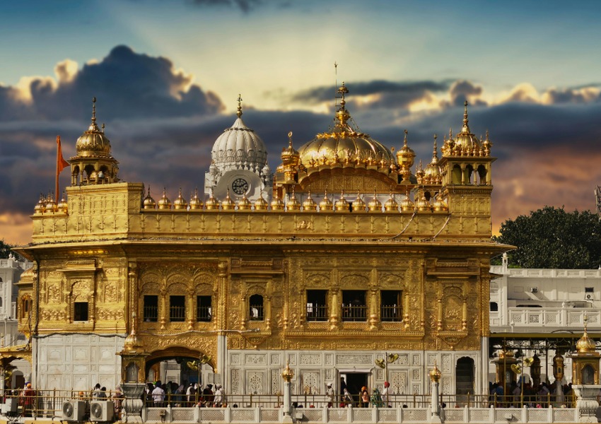 Golden Temple in Amritsar, India, showcasing its ornate golden architecture at sunset.