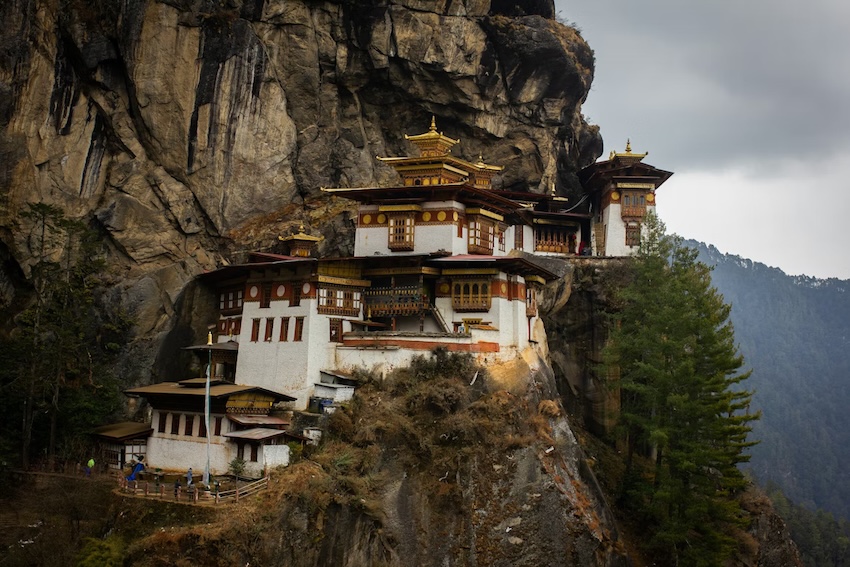 Bhutan's Tiger's Nest Monastery built on a cliffside surrounded by mountains.